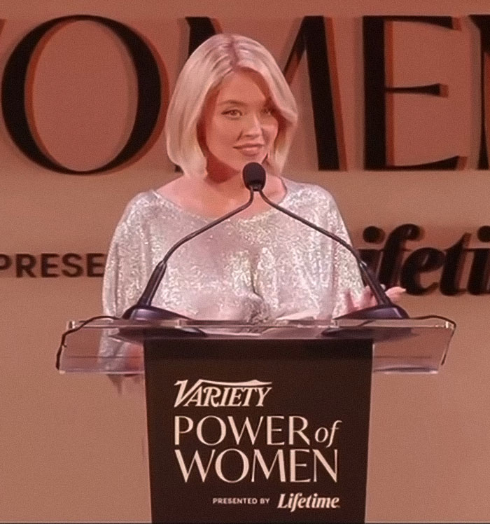 Sydney Sweeney speaking at Variety Power of Women event wearing a controversial see-through outfit promoting pro-modesty.