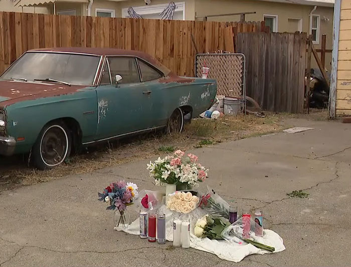 Memorial flowers placed outside a hoarder's home where a missing woman's body was discovered behind a secret wall. Memorial flowers placed outside a hoarder's home where a missing woman's body was discovered behind a secret wall.