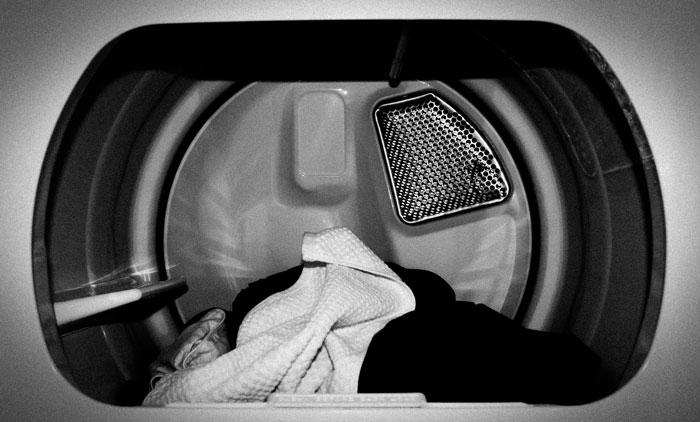 Inside view of a dryer with clothes, illustrating a hilarious instance of people being shockingly unaware of common knowledge.