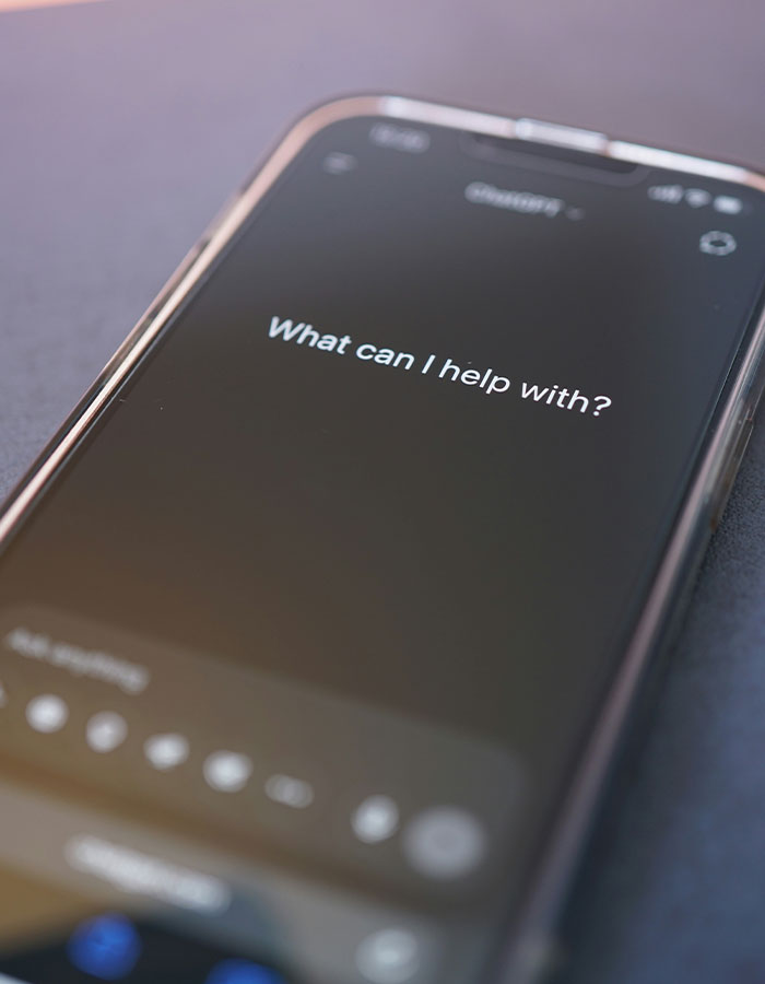 Smartphone screen showing a voice assistant prompt, related to Melania Trump&rsquo;s bizarre AI video conspiracy theory.