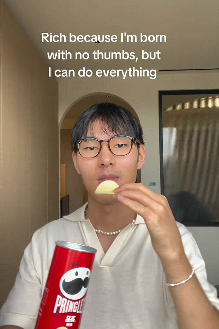 Young man with no thumbs eating chips and holding Pringles can showing genius life hacks and quirky humor online. Young man with no thumbs eating chips and holding Pringles can showing genius life hacks and quirky humor online.