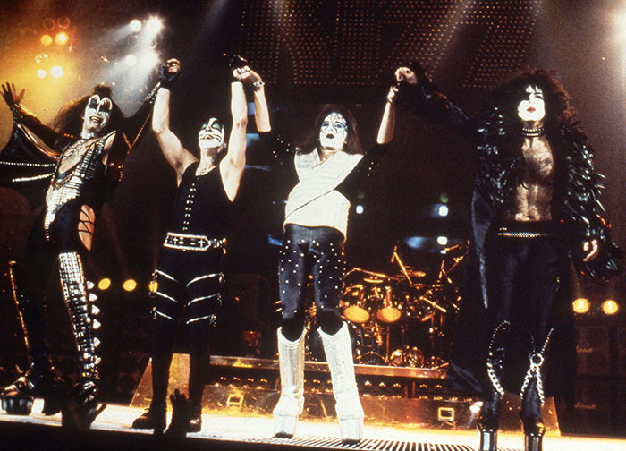 Kiss band members Gene Simmons and Paul Stanley on stage in iconic makeup and costumes during a live concert performance.