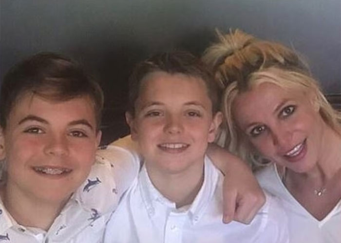 Britney Spears smiling with two boys, sharing a warm moment amid brain damage and heartbreaking confession news.