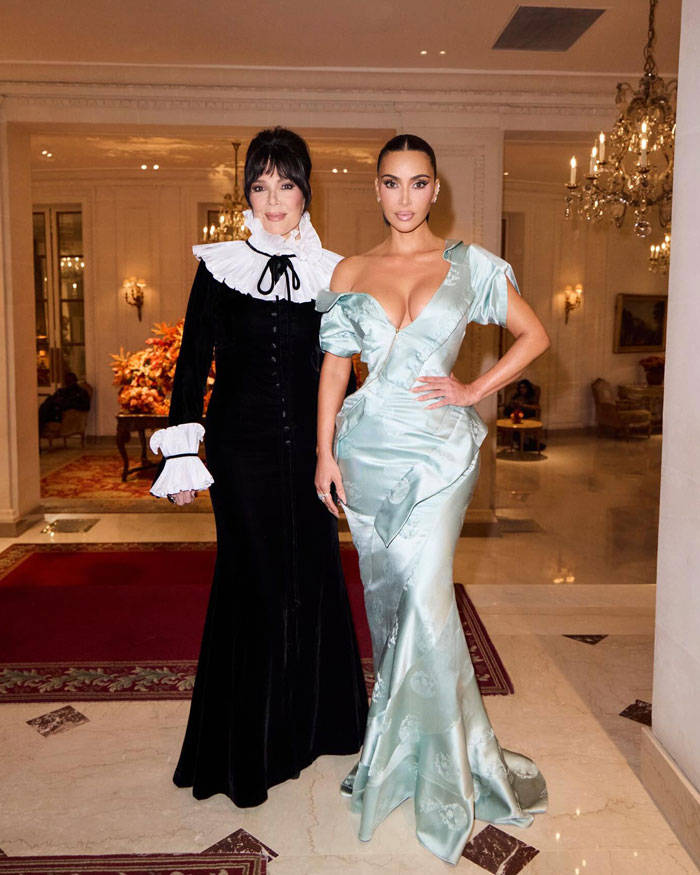 Naomi Watts and Sarah Paulson in elegant gowns alongside Kim Kardashian in a bold braless outfit at a formal event.