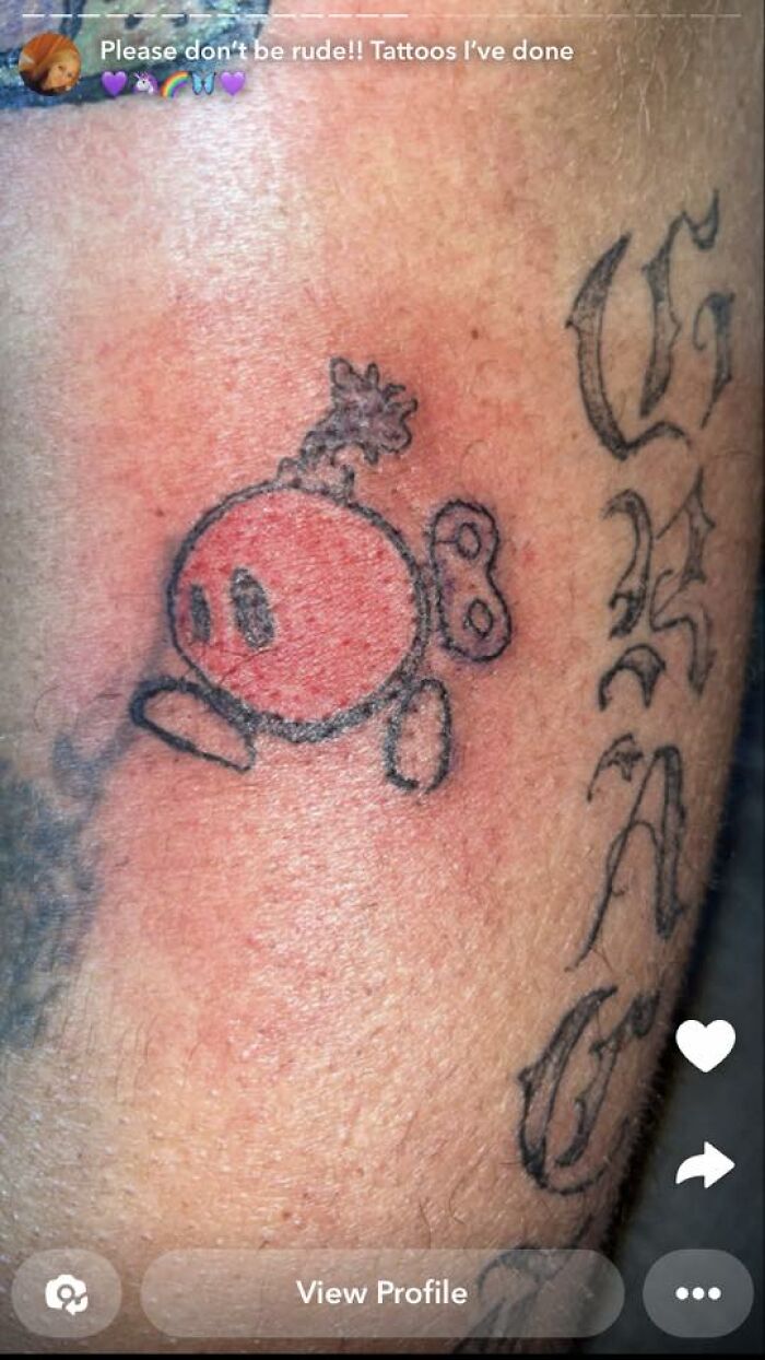 Red and black cartoon-style tattoo with rough lines on red-tinged skin, part of unusual tattoos people allowed on their bodies.