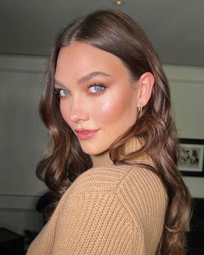 Karlie Kloss posing indoors in a beige sweater, related to Taylor Swift lesbian relationship rumors with Karlie Kloss.