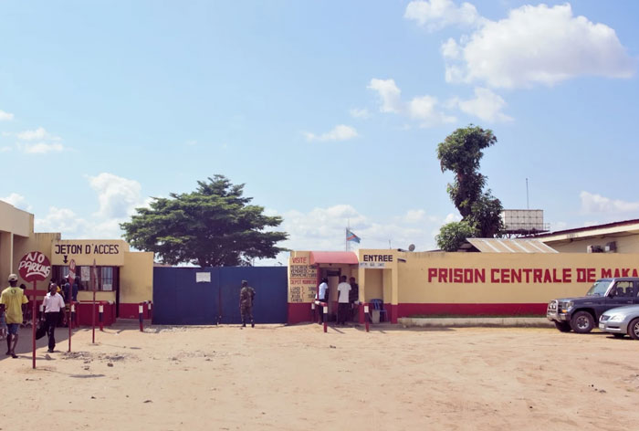 Entrance of a prison with security and visitors outside, illustrating places people wouldn’t revisit even if paid