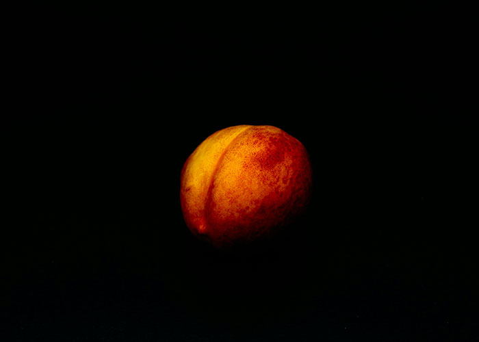 Close-up of a peach with dark background, illustrating the concept of scientists proving you can breathe through your bottom. Close-up of a peach with dark background, illustrating the concept of scientists proving you can breathe through your bottom.