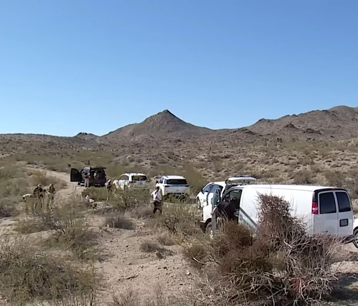 Law enforcement vehicles and personnel conducting urgent investigation in the Las Vegas desert with mountainous terrain. Law enforcement vehicles and personnel conducting urgent investigation in the Las Vegas desert with mountainous terrain.