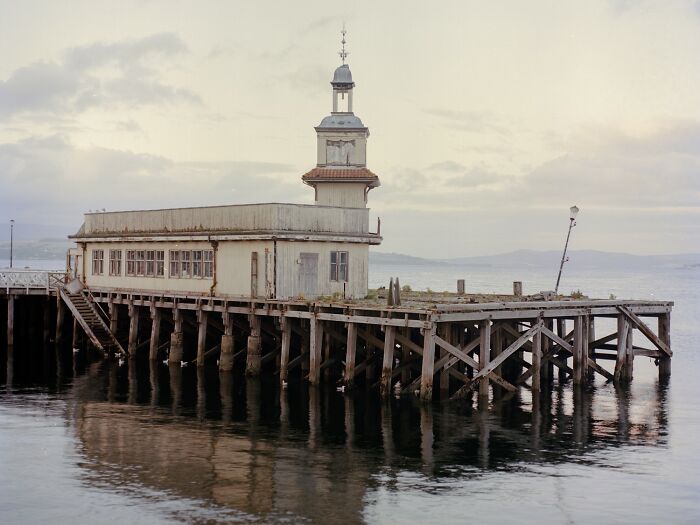 Young woman with freckles wearing a red and beige jacket, featured in award-winning photos from the 2025 Photographer of the Year contest