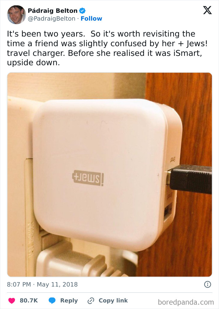 Upside down travel charger plugged into an outlet, a funny accidental moment in everyday life.