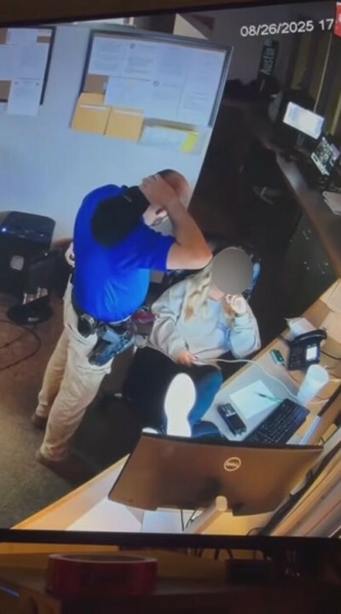 Police chief and 18-year-old dispatcher in office setting captured in a leaked video showing a disturbing moment.