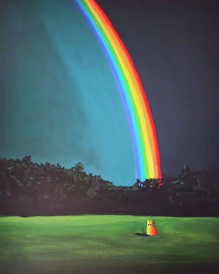 Surreal cat world with an orange cat sitting on grass under a vivid rainbow in a dreamlike landscape at night.
