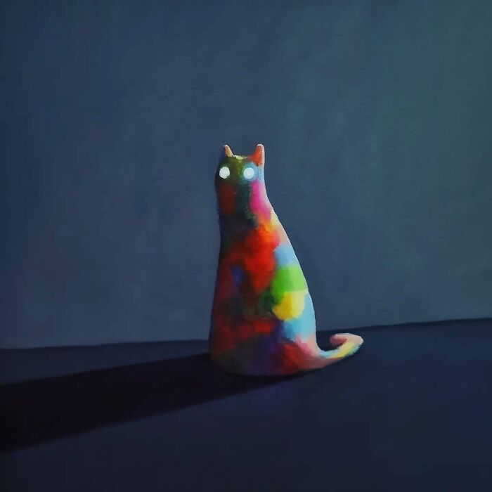 Colorful surreal cat sculpture with glowing eyes in a dark dreamscape, showcasing unique surreal cat worlds by Berlin artist.