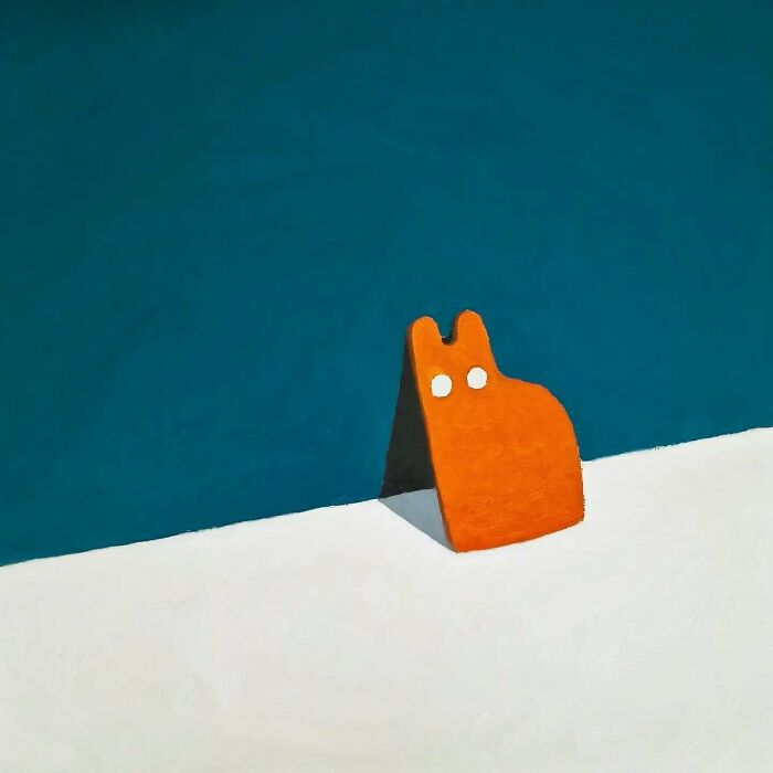 Surreal cat artwork featuring an orange cat figure against a blue and white dreamscape background.