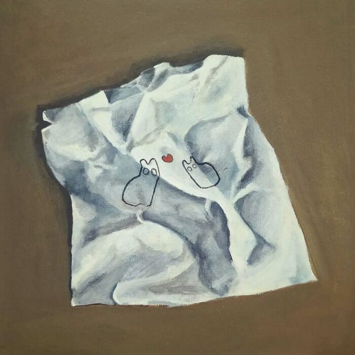 Surreal cat world artwork featuring simple cat illustrations and a small red heart on a textured white fabric background.