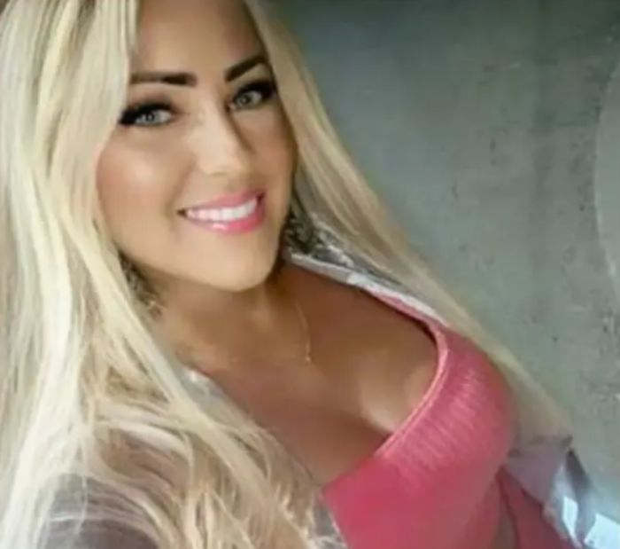 Blonde woman smiling at the camera wearing a pink top, related to angel-faced serial criminal chilling confession news.