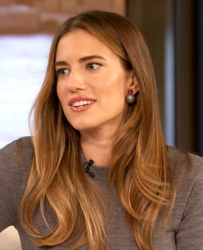 Allison Williams speaking candidly in an interview, discussing privilege and nepo babies with expressive gestures.