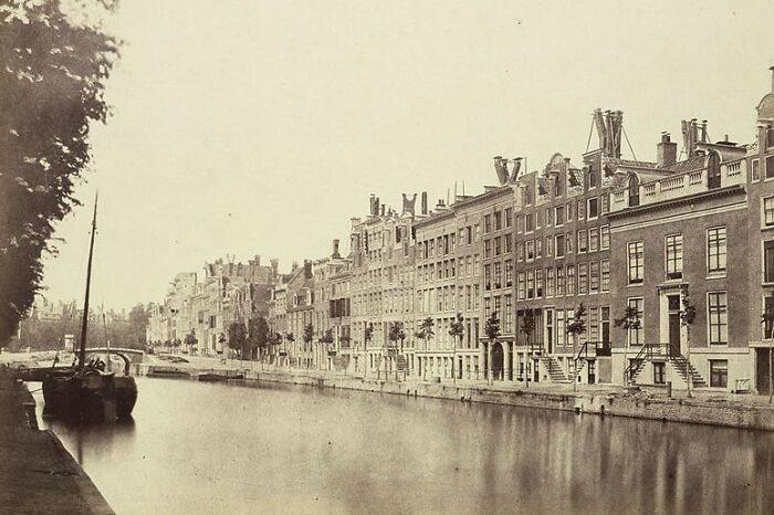 Historic black and white photo showing a world capital city with canals and classic architecture from before modern times.