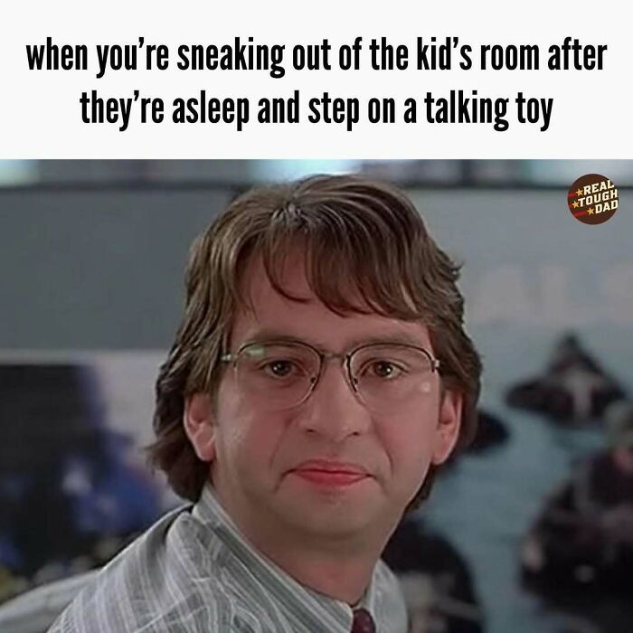 Man with glasses making a pained expression representing relatable parenting memes about stepping on a talking toy at night.