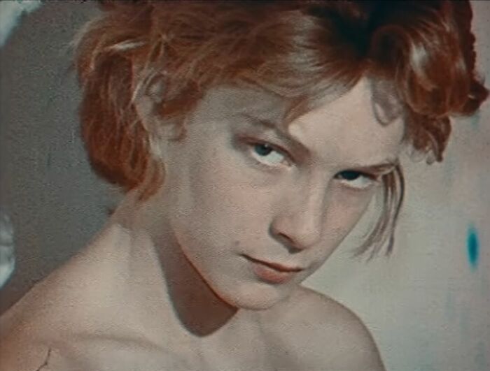 Young actor known as the most beautiful boy in the world with striking blue eyes and red hair in a close-up portrait.