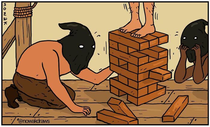Humorous one-panel comic showing hooded figures playing unstable Jenga with a person standing on top of the tower.