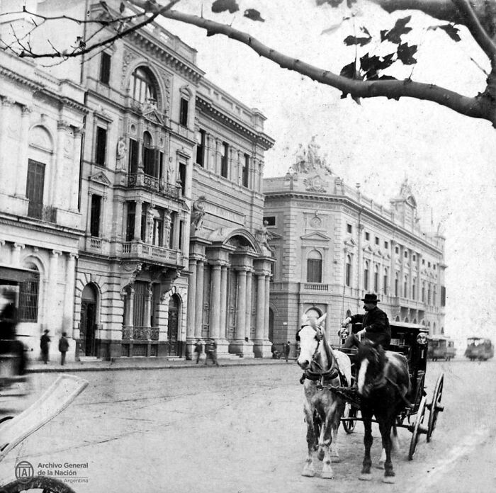 Historic black and white photo showing a horse-drawn carriage on a city street in one of the world’s old capitals.