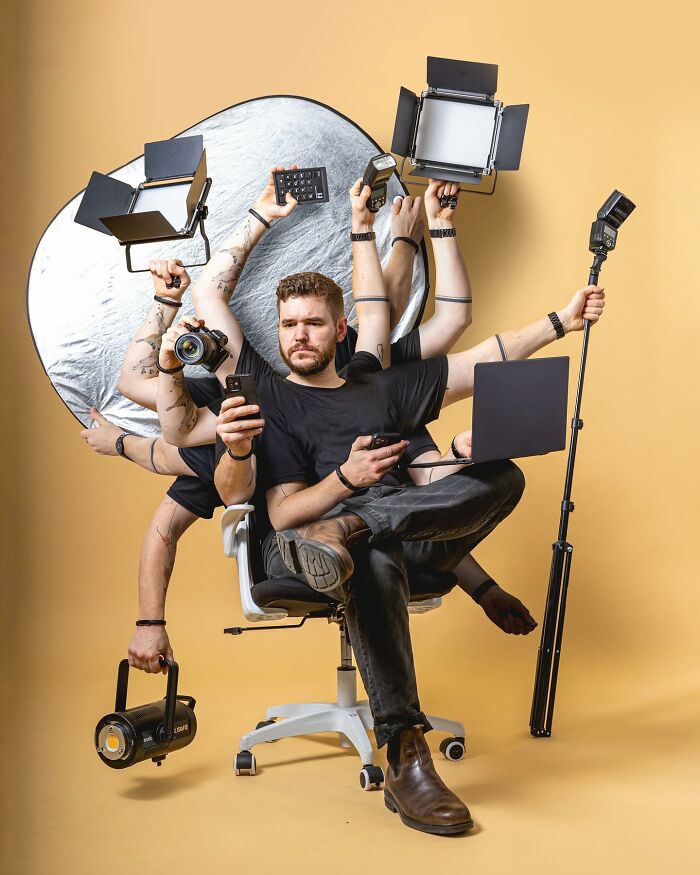 Photographer with multiple arms holding lighting, camera, laptop, and phone showcasing logic-challenging photo manipulations.