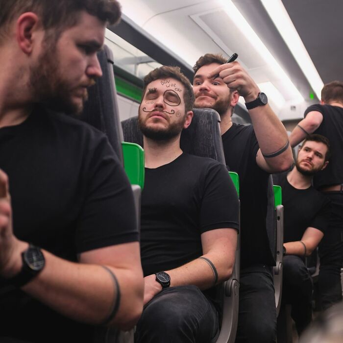 Multiple versions of a man in black shirts and watches on a train, showcasing amazing logic-challenging photo manipulations.