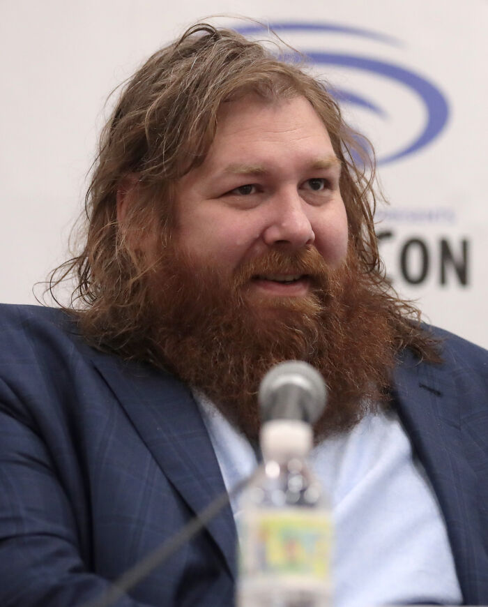 Bearded man speaking at a panel event, representing moments when people were disappointed in someone they idolized.