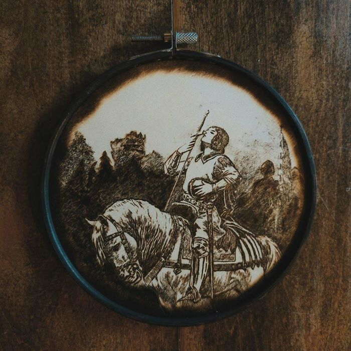 Wood-burned artwork by Canadian artist Kat Slota depicting a knight on horseback created using fire techniques.