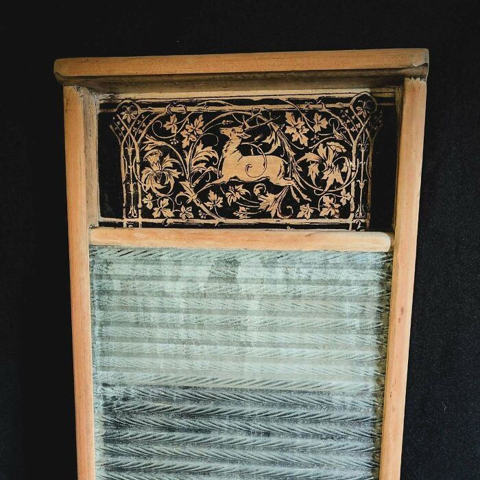 Wood-burned artwork by Canadian artist Kat Slota featuring intricate floral and mythical designs on a wooden panel.