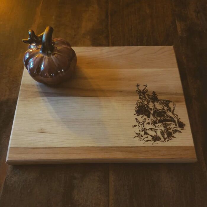 Wood-burned artwork of deer on a wooden board created using fire by Canadian artist Kat Slota.