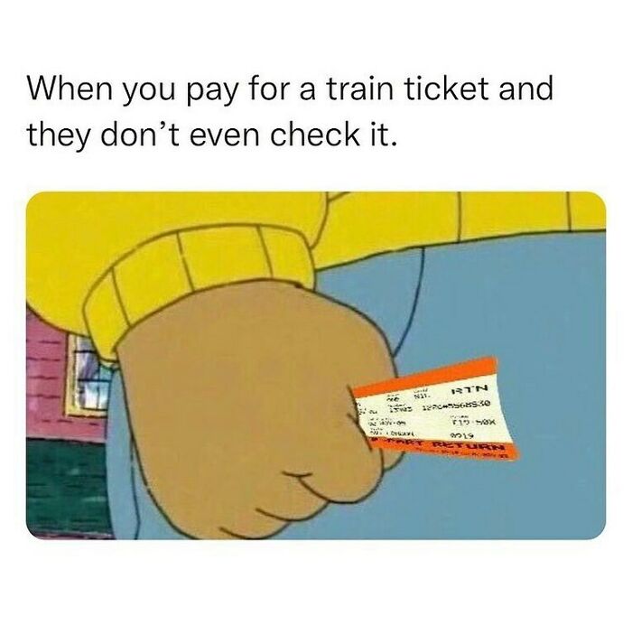 Close-up of a clenched fist holding a train ticket, illustrating a relatable unapologetically British meme moment.