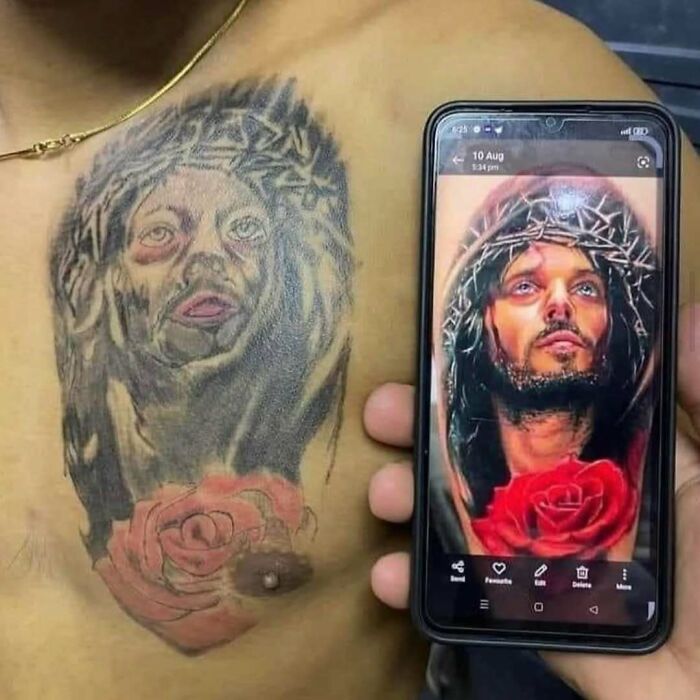 Tattoo of Jesus with a crown of thorns and rose, compared with a detailed reference image on a phone.