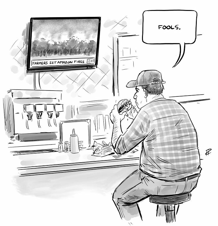 Man eating burger at counter watching news about Amazon fires, a comic sparking important conversations about today's world.