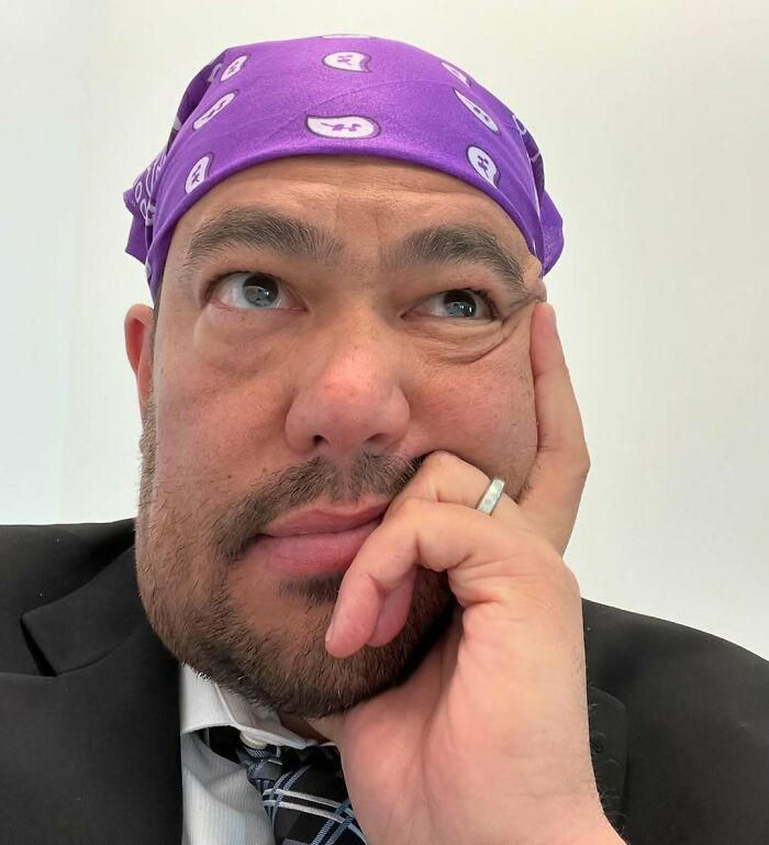 Man wearing a purple bandana with a contemplative expression, representing Halloween fails and spooky day disappointment.