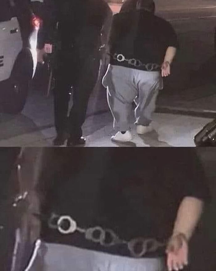 Person walking at night wearing handcuffs attached to belt, a humorous post that hits different at 3AM.