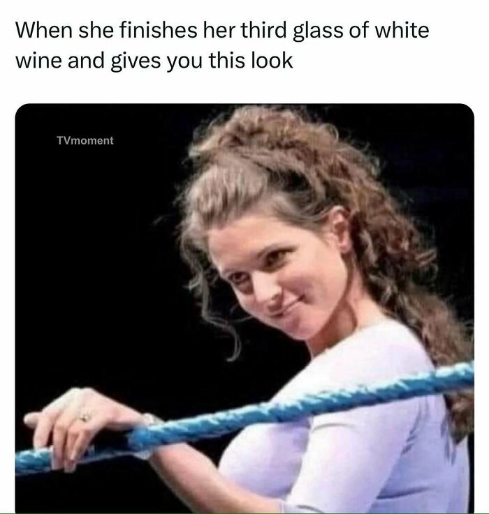 Woman giving a playful look after finishing her third glass of white wine, a funny and relatable TV meme moment.