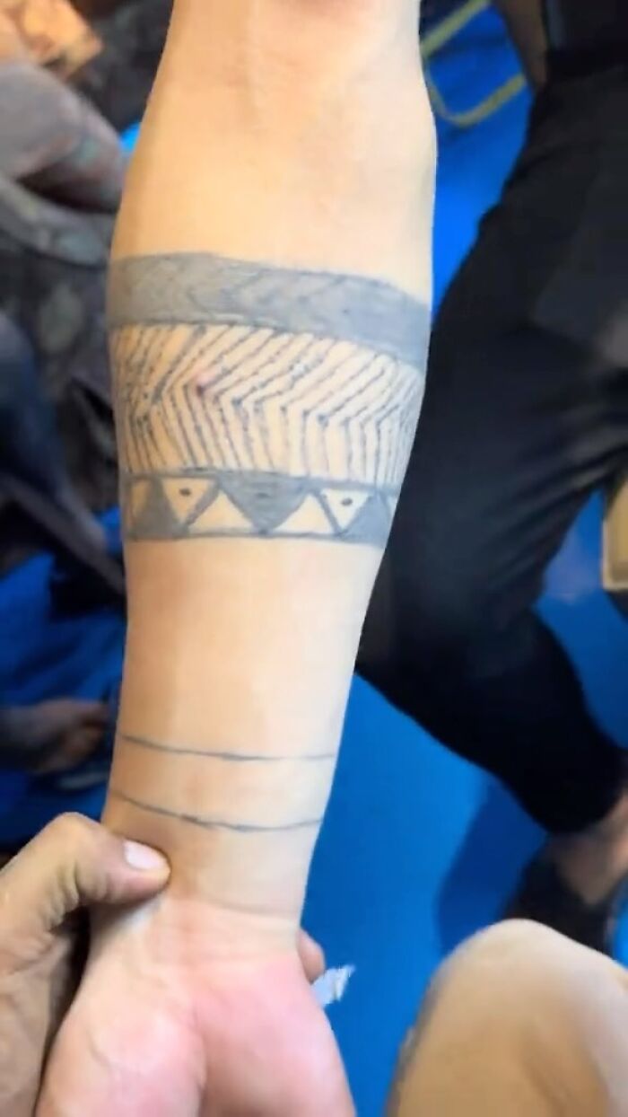 Forearm with multiple tribal-style tattoos showcasing some of the awful tattoos people might regret getting.