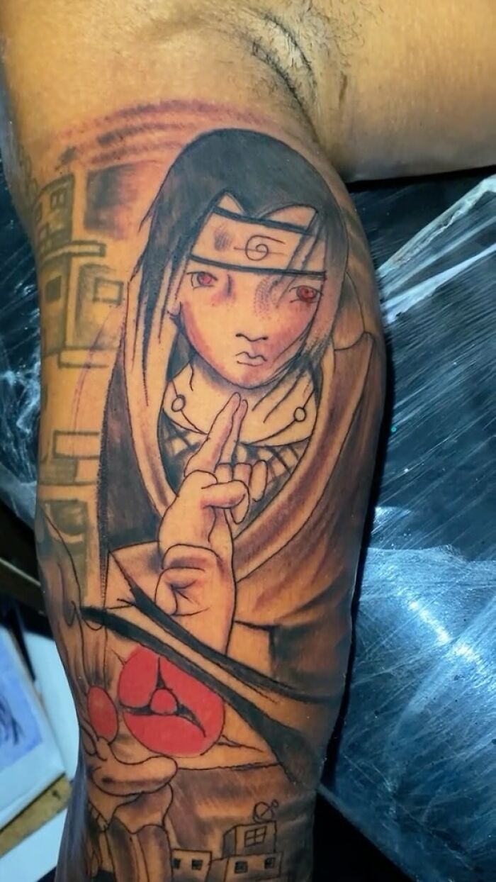 Tattoo of an anime character with red eyes and hand gestures, one of the 75 awful tattoos from people allergic to smart decisions