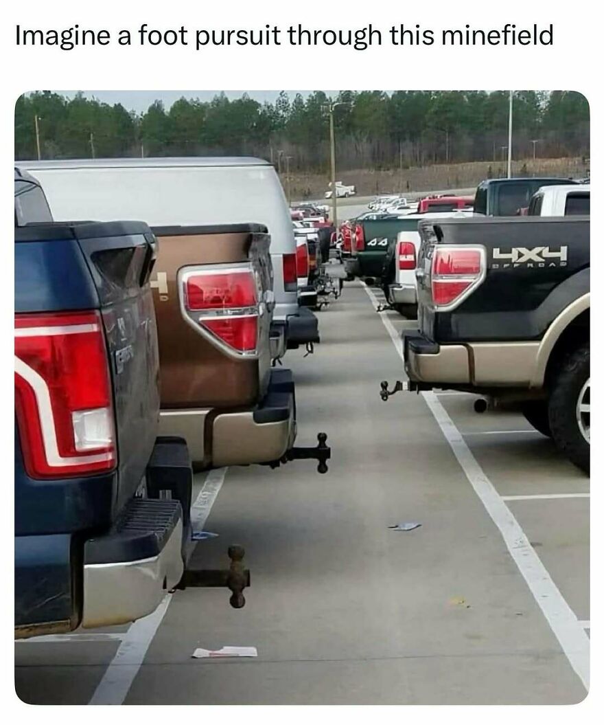 Several pickup trucks parked closely with protruding trailer hitches resembling a minefield, funny dads memes theme.