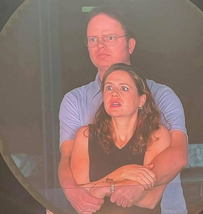 Couple with surprised expressions in an embrace, captured in a scene often used in funny and relatable TV memes.