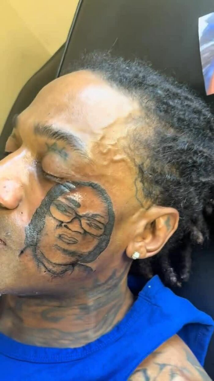 Close-up of a man with a poorly done face tattoo portrait, highlighting awful tattoos and questionable tattoo decisions.