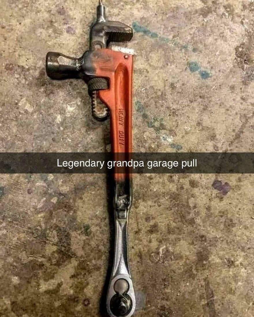 Combination of wrench and ratchet tool on a garage floor illustrating dad humor and dad memes about tools.