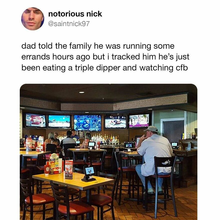 Man wearing a cap sitting alone in a bar eating a triple dipper and watching sports, showcasing typical dad behavior meme.