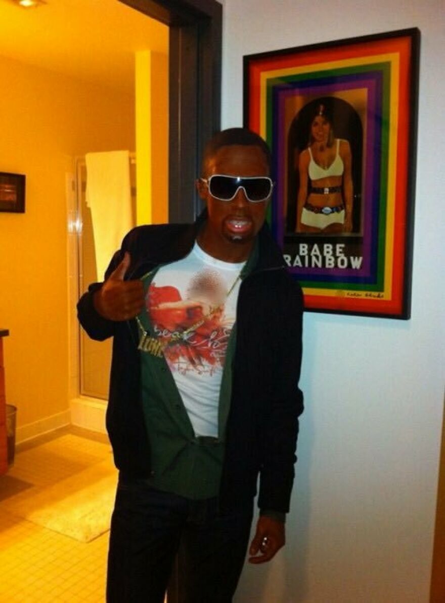 Man in oversized sunglasses and casual clothes posing indoors, showcasing celebrity Halloween costume lacking common sense.