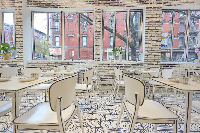 2D restaurant interior in NYC with black and white drawing-style chairs, tables, and patterned floor and walls. 2D restaurant interior in NYC with black and white drawing-style chairs, tables, and patterned floor and walls.