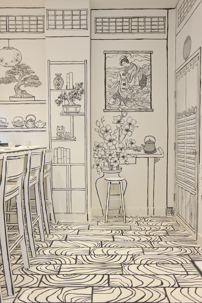 Interior of a 2D restaurant in NYC with black and white hand-drawn style furniture and decor creating a drawing-like effect. Interior of a 2D restaurant in NYC with black and white hand-drawn style furniture and decor creating a drawing-like effect.