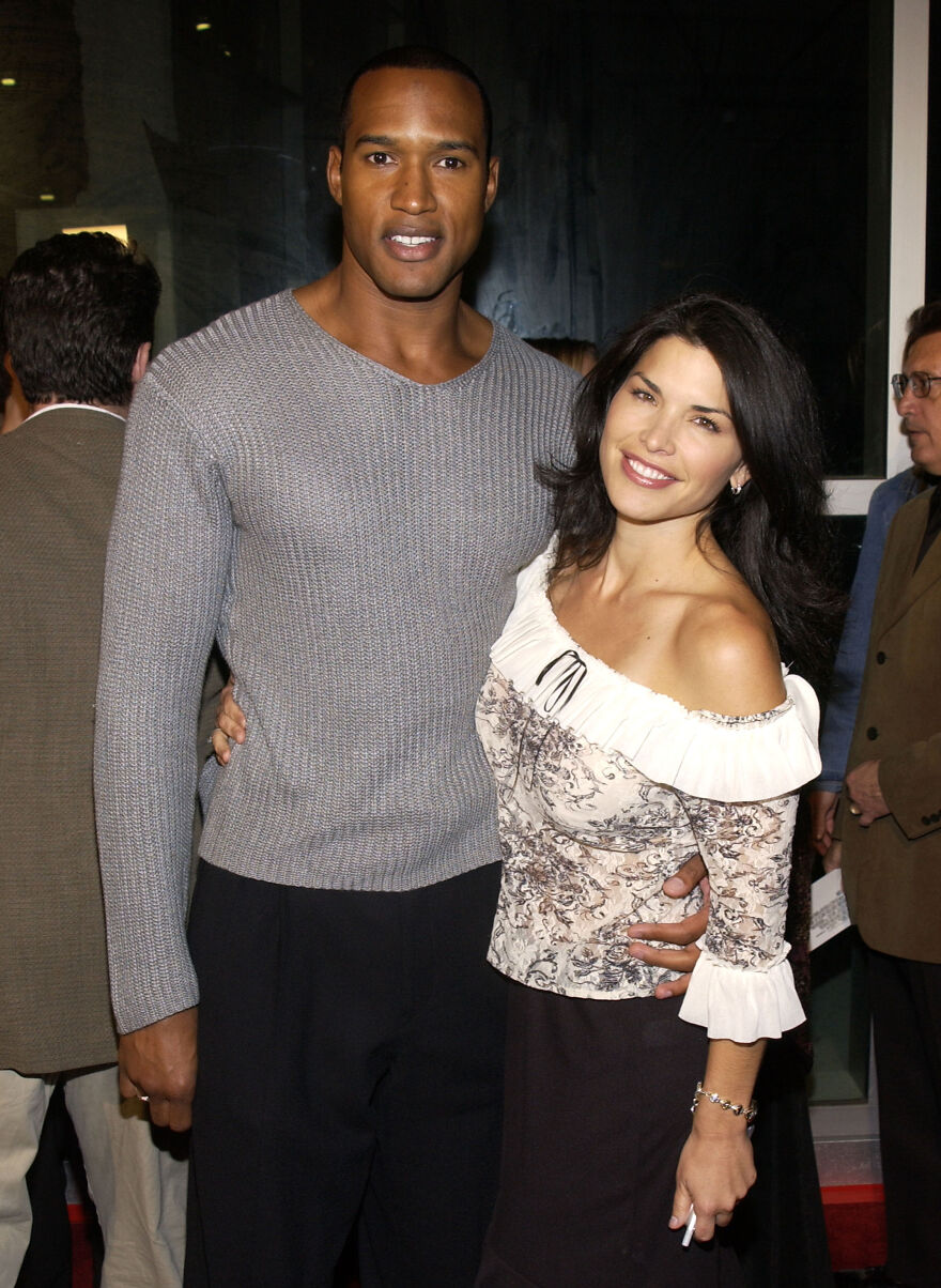 Lauren S&aacute;nchez young throwback photo smiling with a man at an indoor event wearing casual attire.